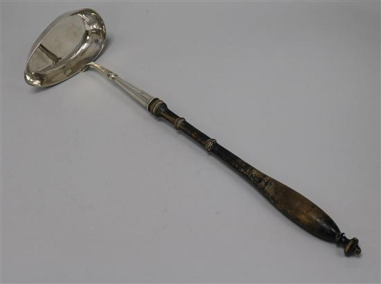 An early 19th Century Swedish silver ladle with turned wooden handle, date letter for 1837, 41.5cm.